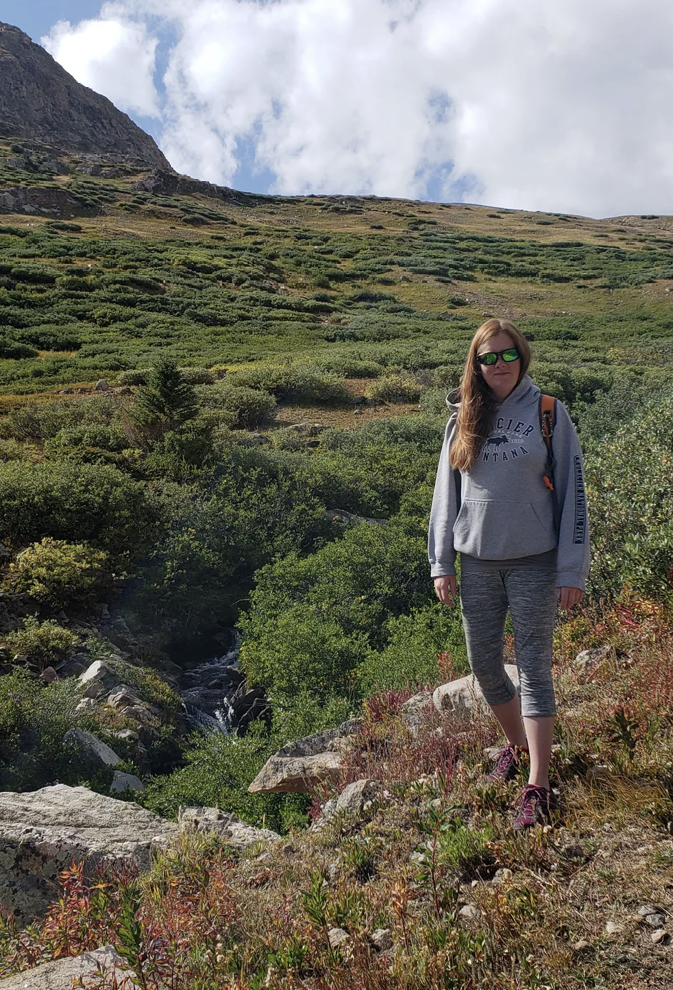 Jessica, founder of Lotus Bookkeeping, outdoors in the Colorado mountains